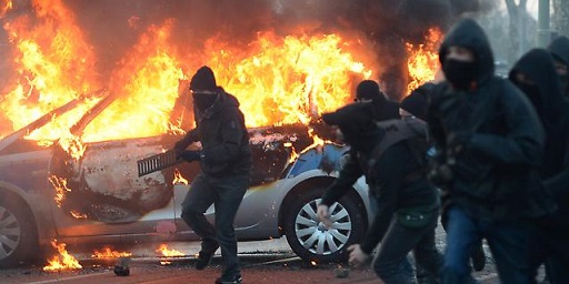 Un'auto incendiata durante le proteste a Francoforte del movimento anticapitalista Blockupy, 18 marzo 2015 (AP Photo/Michael Probst)